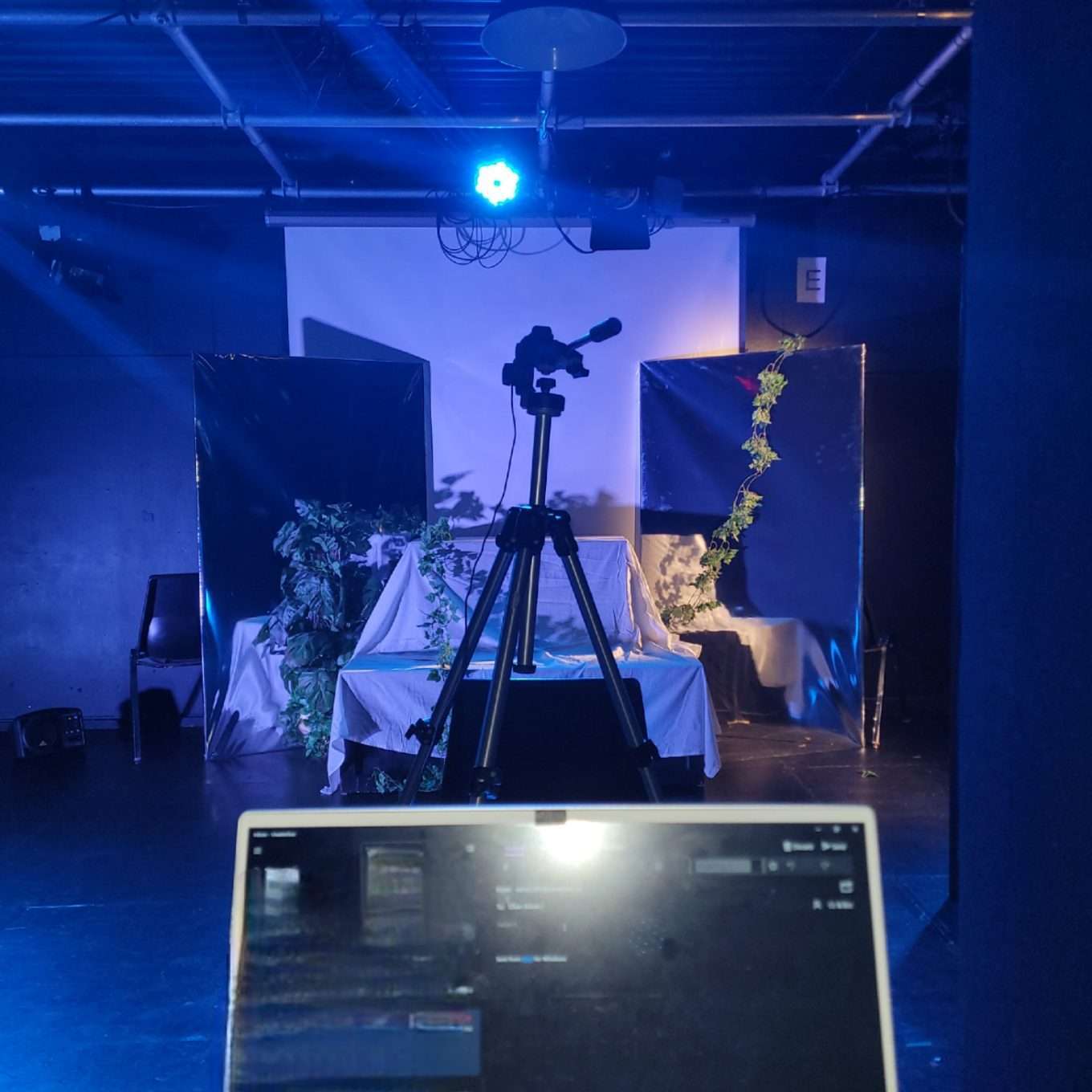 Lilian Adom (Astoria), Angelo Feliciano (Cyrus). View of Centre Stage and Audience Seating Placement. Rehearsal photos of Scenes 5 to 9 of "The Inevitable" by Emily Radcliffe. UWaterloo 'THPERF 361: Approaches to Directing'. Winter 2022. Directed by Emily Radcliffe. Set/Light/Costume/Sound Design by Emily Radcliffe.